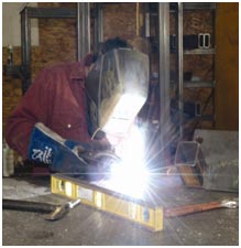 welder working on a metal frame