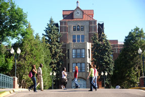 students cross campus in front of McMullen Hall on the main MSUB campus