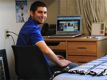 a student at his desk in his residence hall room