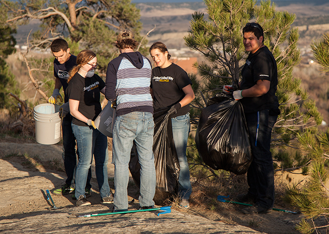 Lacey and other volunteers pick up litter atop the Rims