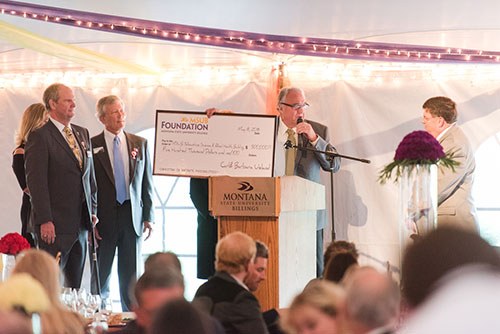 Carl Uleland presents check to MSUB Foundation president Bill Kennedy