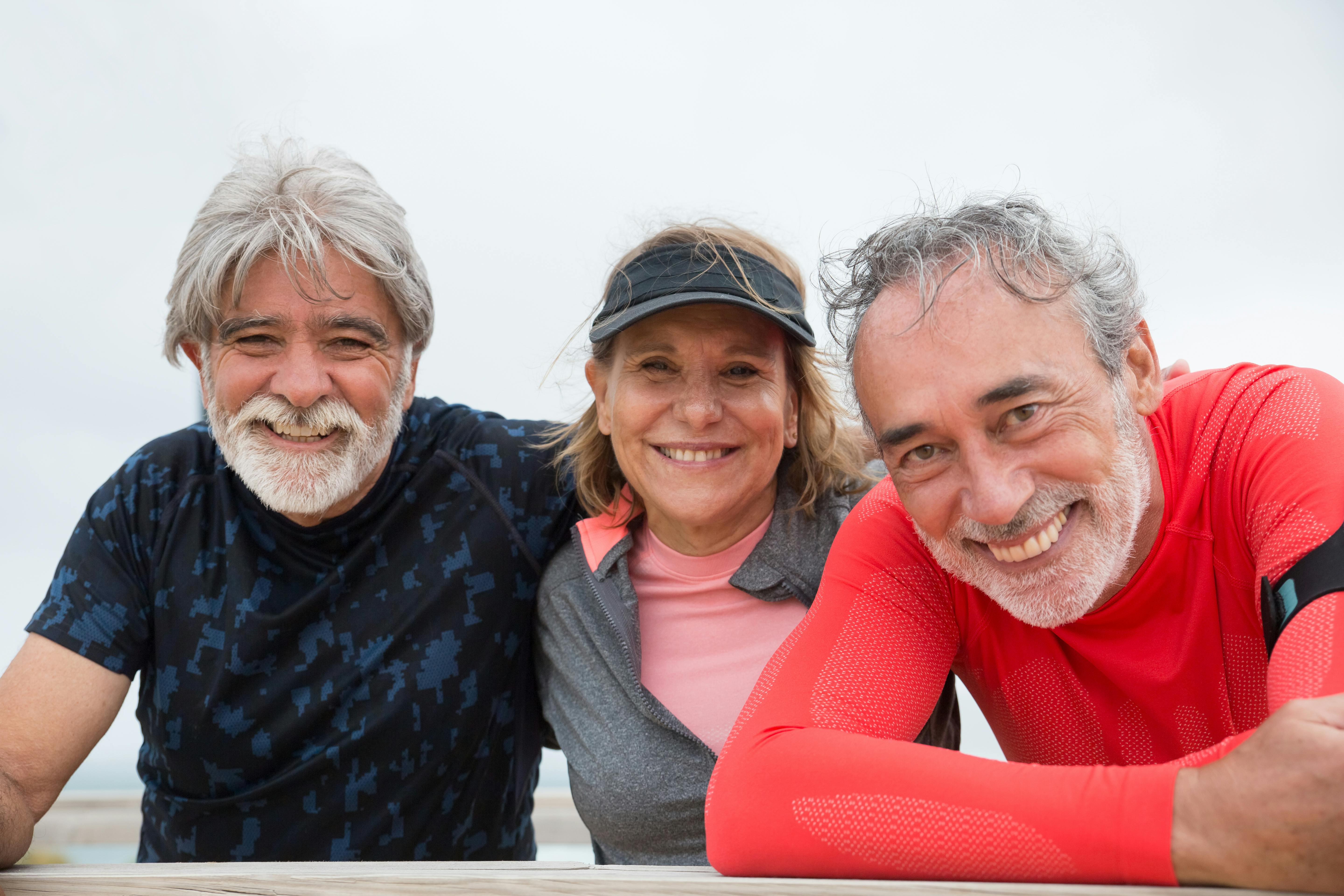 Three elderly people smiling