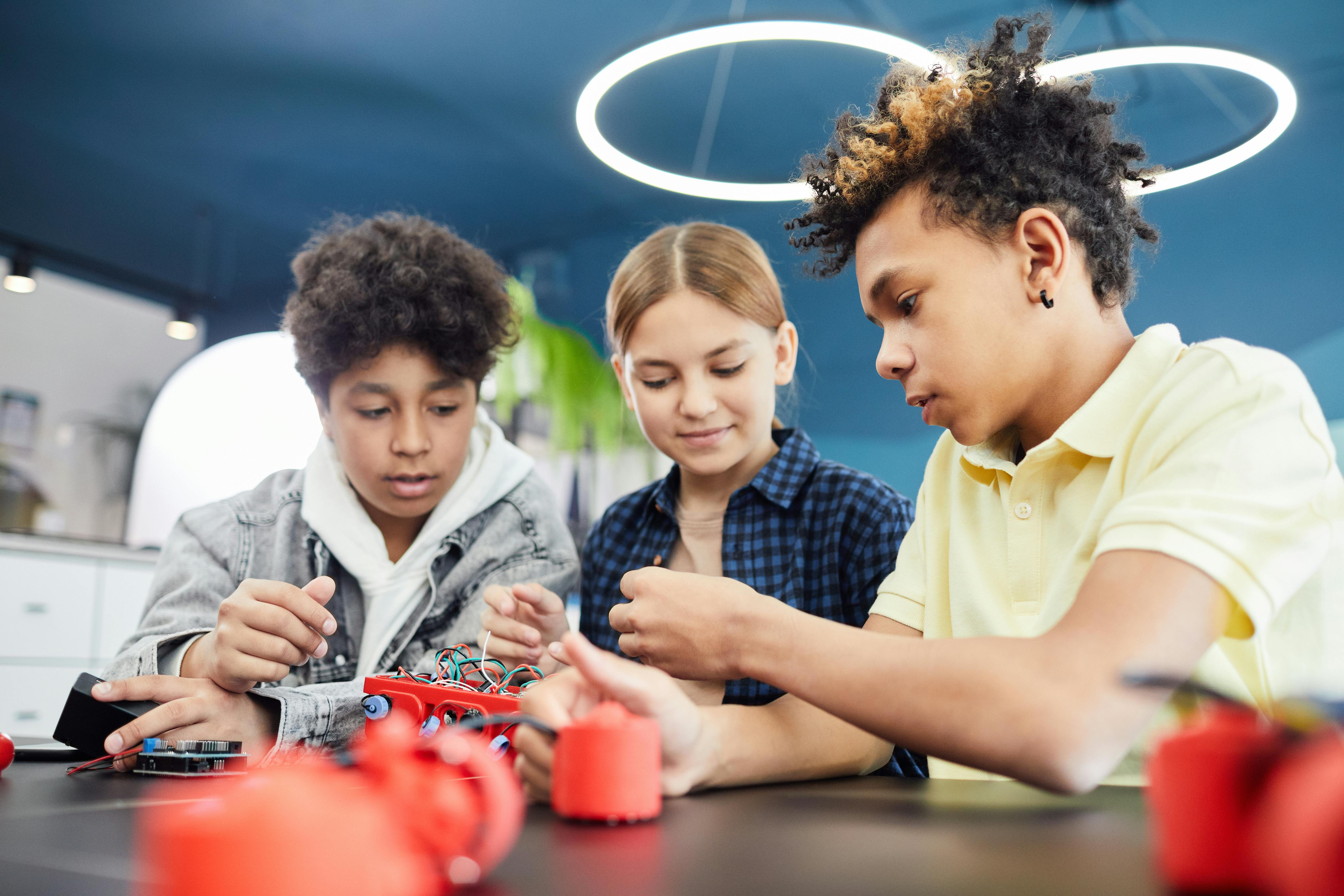 Three school children working on a STEM project