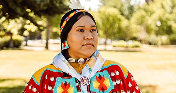 Native American woman dressed for a powwow