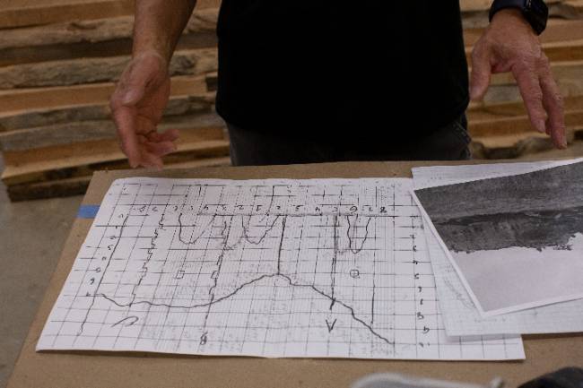 Foon Sham showing sketches of "Ghost Cave"