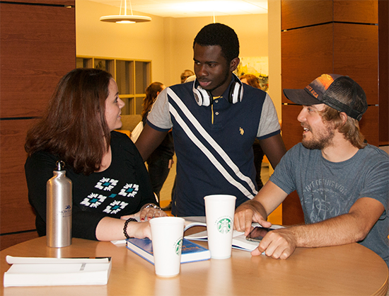 three students gathering for beverages in the Student Union Building