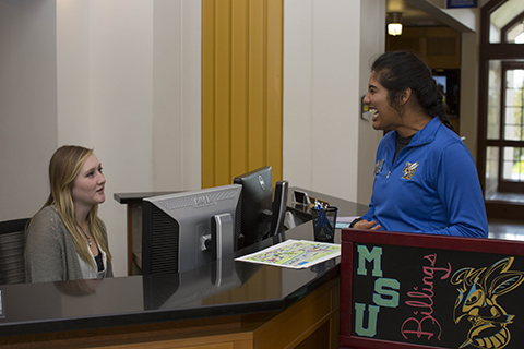 Students talk near a desk