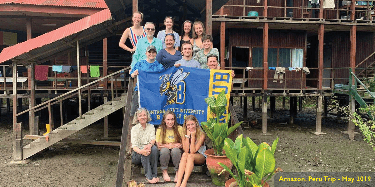 MSUB student in Iquitos, Peru with banner