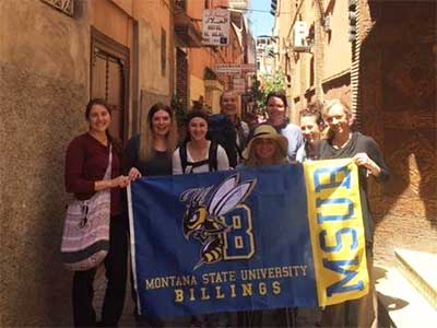 MSUB students on Morocco trip with MSUB flag