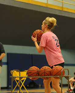 A woman playing basketball
