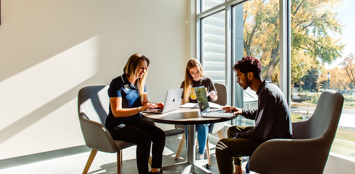 Three students studying at a table