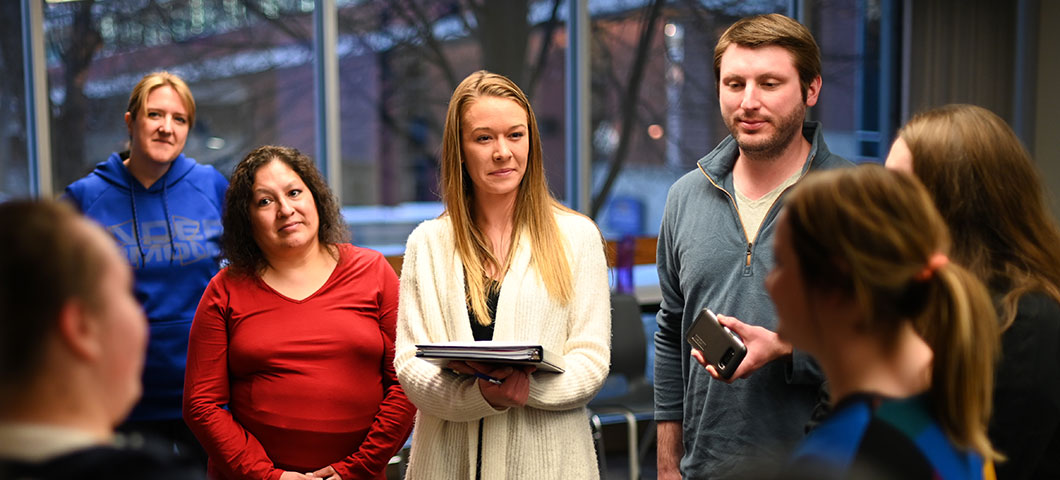 A student in a lab coat with other students