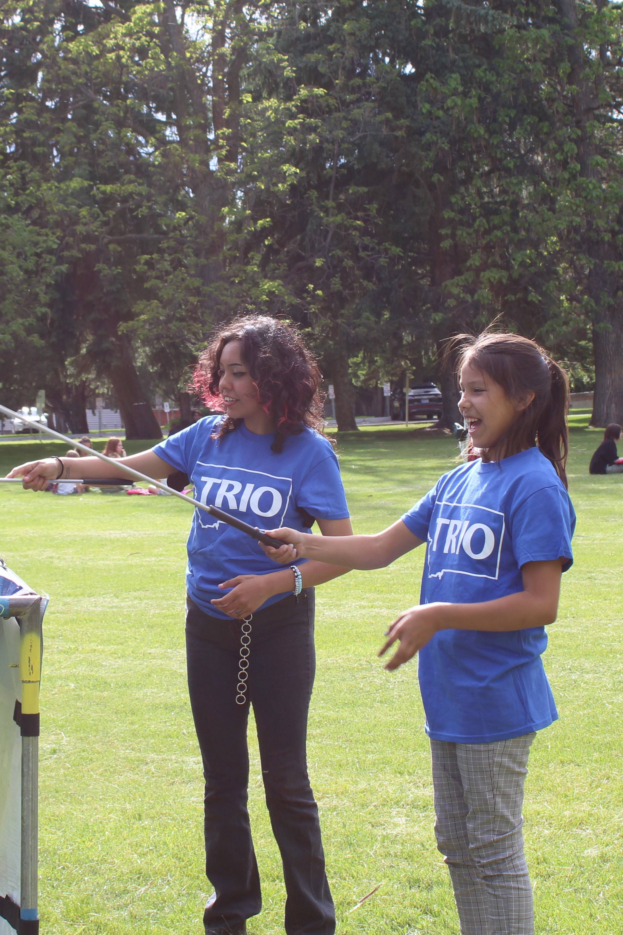 Two TRIO students playing a yard game at a Talent Search Picnic