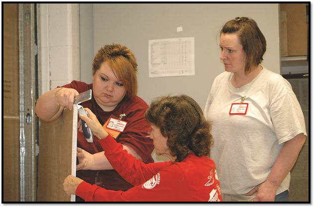 A representative from Habitat for Humanity works with two women at the Montana Women’s Prison during some hands-on construction training at the prison last fall.