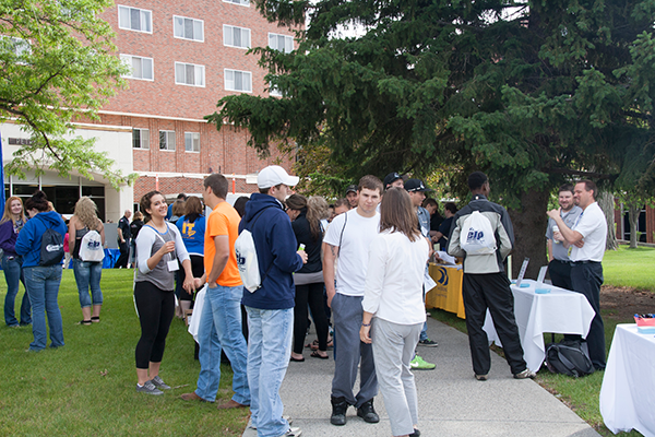 students mingle outdoors on the MSUB University campus